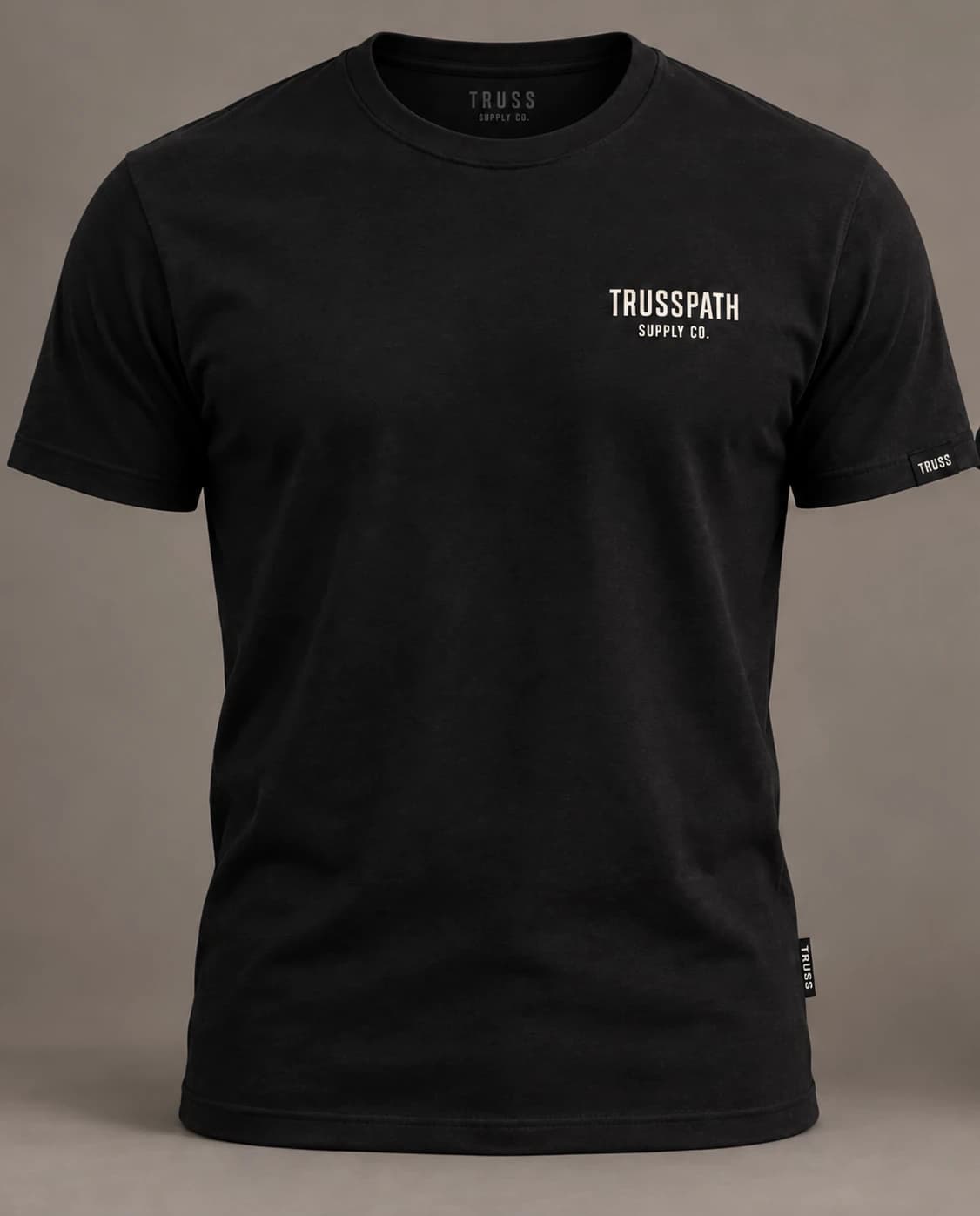The Black Logo Tee — front view on a black t-shirt, garment mockup